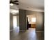Open floor plan featuring wood-look flooring leading to kitchen with black appliances at 10342 Spider Rock Ave, Las Vegas, NV 89135