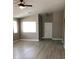 A bright living room with a ceiling fan and modern laminate flooring and a large window at 10342 Spider Rock Ave, Las Vegas, NV 89135