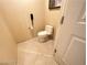 Cozy half bathroom features a modern toilet, neutral wall, and tiled floors at 125 E Harmon Ave # 2718, Las Vegas, NV 89109