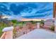 Balcony view with desert landscape and a colorful sunset over mountains in the background at 1367 Minuet St, Henderson, NV 89052