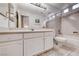 Well-lit bathroom with double vanity, a large mirror, and a bathtub with shower at 1367 Minuet St, Henderson, NV 89052