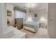 Cozy bedroom featuring a chandelier, soft natural light, and carpeted floors at 1367 Minuet St, Henderson, NV 89052