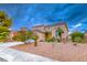 Beautiful two-story home with a well-maintained lawn, desert landscaping, and mature trees at 1367 Minuet St, Henderson, NV 89052