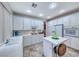 All-white kitchen with modern appliances, ample cabinet space, and a functional center island at 1367 Minuet St, Henderson, NV 89052