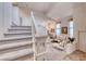 Bright living room featuring high ceilings, a chandelier, and staircase to the second level at 1367 Minuet St, Henderson, NV 89052