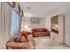 Sitting room featuring floral couches, natural light and built in storage at 1367 Minuet St, Henderson, NV 89052