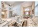 Open-concept living room with high ceilings, chandelier, and seamless flow into the dining area at 1367 Minuet St, Henderson, NV 89052