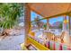 Covered patio with a swing and seating, offering a serene view of the landscaped backyard at 1367 Minuet St, Henderson, NV 89052