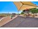 The community playground offers slides and climbing structures with a shaded canopy and desert landscape at 1367 Minuet St, Henderson, NV 89052