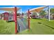 A well-equipped playground with slides, climbing structures and sun shades on artificial turf at 1367 Minuet St, Henderson, NV 89052