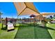 A fun playground features a slide, climbing structures, and a shaded canopy with desert landscape views at 1367 Minuet St, Henderson, NV 89052
