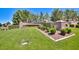 A lush green lawn and mature trees frame the beautiful stone entrance to Coventry Homes at 1367 Minuet St, Henderson, NV 89052