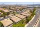 Aerial view featuring community homes with tile roofs, desert landscaping, and paved streets at 1433 Overseer Ave, Henderson, NV 89074