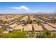 Wide aerial view of a community featuring desert landscaping,tile roofs, and paved roads at 1433 Overseer Ave, Henderson, NV 89074