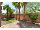 Backyard featuring palm trees, hardscape patio, turf, and brick wall at 1433 Overseer Ave, Henderson, NV 89074