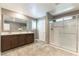 Modern bathroom featuring a double sink vanity, sleek countertops, and walk-in shower with glass door at 1433 Overseer Ave, Henderson, NV 89074