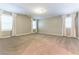Expansive bedroom featuring neutral carpet, large windows with curtains, and ample space at 1433 Overseer Ave, Henderson, NV 89074
