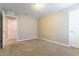Neutral bedroom featuring plush carpeting, fresh walls, and an adjacent door at 1433 Overseer Ave, Henderson, NV 89074
