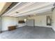 Spacious garage with epoxy floor, storage cabinets, and water heater at 1433 Overseer Ave, Henderson, NV 89074