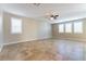 Bright living room featuring tile flooring, multiple windows, and a ceiling fan for added comfort at 1433 Overseer Ave, Henderson, NV 89074