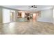 Open concept living space with tile floors seamlessly connecting the kitchen and living areas at 1433 Overseer Ave, Henderson, NV 89074