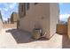 View of the backyard showcasing the neutral-colored siding and the AC unit at 1799 Passerine St, Las Vegas, NV 89138