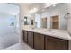 Stylish bathroom with double vanity, quartz countertop, and adjacent walk-in closet at 1799 Passerine St, Las Vegas, NV 89138