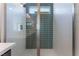 Modern bathroom shower featuring green tile accent wall and glass door at 1799 Passerine St, Las Vegas, NV 89138
