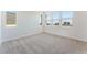 Bright bedroom with plush carpet, large windows offering views and filling the space with natural light at 1799 Passerine St, Las Vegas, NV 89138