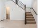 Bright entryway with tiled floors, modern staircase and convenient access to a powder room on the main level at 1799 Passerine St, Las Vegas, NV 89138