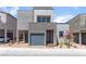 Modern two-story home with a gray exterior, attached garage, and small landscaped yard at 1799 Passerine St, Las Vegas, NV 89138