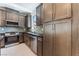 Modern kitchen with dark cabinets, stainless steel appliances, and ample storage space at 1799 Passerine St, Las Vegas, NV 89138