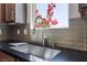 Close-up of a stainless steel kitchen sink with modern faucet and tiled backsplash at 1799 Passerine St, Las Vegas, NV 89138