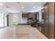 Open kitchen with a center island, dark cabinets, stainless steel appliances, and ample counter space at 1799 Passerine St, Las Vegas, NV 89138