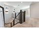 Open staircase featuring metal railings, carpeted steps, and natural light from windows at 1799 Passerine St, Las Vegas, NV 89138