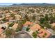 Aerial view of a neighborhood featuring lush landscaping, mature trees, and a community pool at 1990 Freeman Ct, Henderson, NV 89014