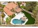 A bird's eye view features a home with a sparkling pool, inviting lounge area, and manicured green spaces at 1990 Freeman Ct, Henderson, NV 89014