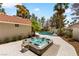 Landscaped backyard featuring a large hot tub adjacent to the pool, with mature palm trees adding privacy and shade at 1990 Freeman Ct, Henderson, NV 89014