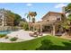 Resort-style backyard with a pool, covered patio, lounge chairs, and meticulous landscaping at 1990 Freeman Ct, Henderson, NV 89014
