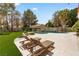 Backyard features a private pool, sun loungers, and lush landscaping, perfect for relaxation at 1990 Freeman Ct, Henderson, NV 89014