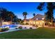 Lush backyard oasis featuring a sparkling pool, covered patio, and well-maintained landscaping at 1990 Freeman Ct, Henderson, NV 89014