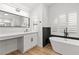 Bright bathroom featuring a vanity, modern fixtures, and a standalone tub at 1990 Freeman Ct, Henderson, NV 89014