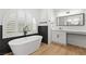Modern bathroom featuring a freestanding tub, sleek fixtures, and a vanity area with natural light at 1990 Freeman Ct, Henderson, NV 89014