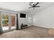 Bright bedroom with neutral carpet, ceiling fan, french doors to patio, and a TV for relaxed viewing at 1990 Freeman Ct, Henderson, NV 89014