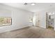 Spacious bedroom with a window and bright lighting, featuring plush carpeting at 1990 Freeman Ct, Henderson, NV 89014