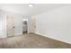 Bright bedroom featuring neutral carpet, white walls, bathroom access, and modern doors at 1990 Freeman Ct, Henderson, NV 89014