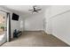 Bright bedroom featuring a ceiling fan, carpet, and access to the backyard at 1990 Freeman Ct, Henderson, NV 89014