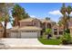Charming two-story home boasts a three-car garage, desert landscaping, and a welcoming curb appeal at 1990 Freeman Ct, Henderson, NV 89014