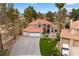 Beautiful two-story home with a three-car garage and desert landscaping showcasing its inviting curb appeal at 1990 Freeman Ct, Henderson, NV 89014
