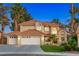 Stunning two-story home with a three-car garage, well-manicured lawn, and desert landscaping at 1990 Freeman Ct, Henderson, NV 89014
